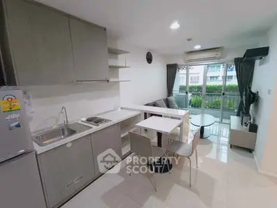 Modern open-layout kitchen and living room with balcony view in a stylish apartment.