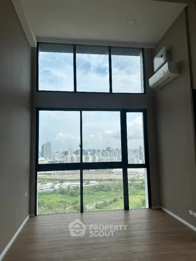 Stunning high-rise apartment with floor-to-ceiling windows offering breathtaking city views.
