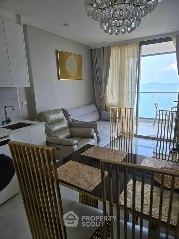 Luxurious living room with ocean view and elegant decor in a modern apartment.