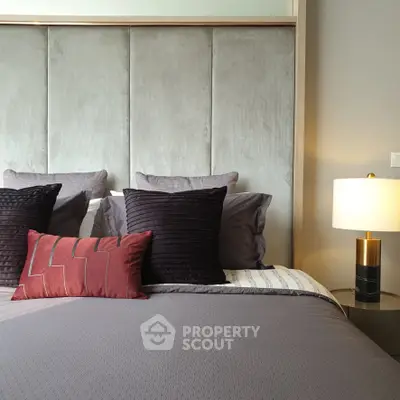 Luxurious bedroom with plush headboard and elegant lighting