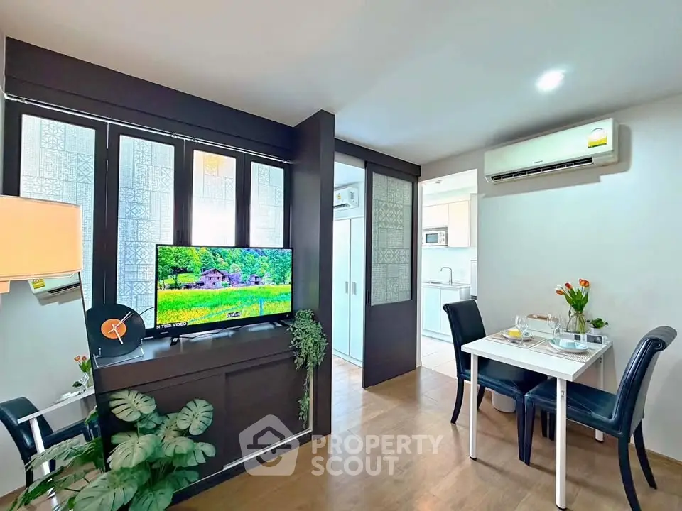 Modern living room with dining area and air conditioning in a cozy apartment.
