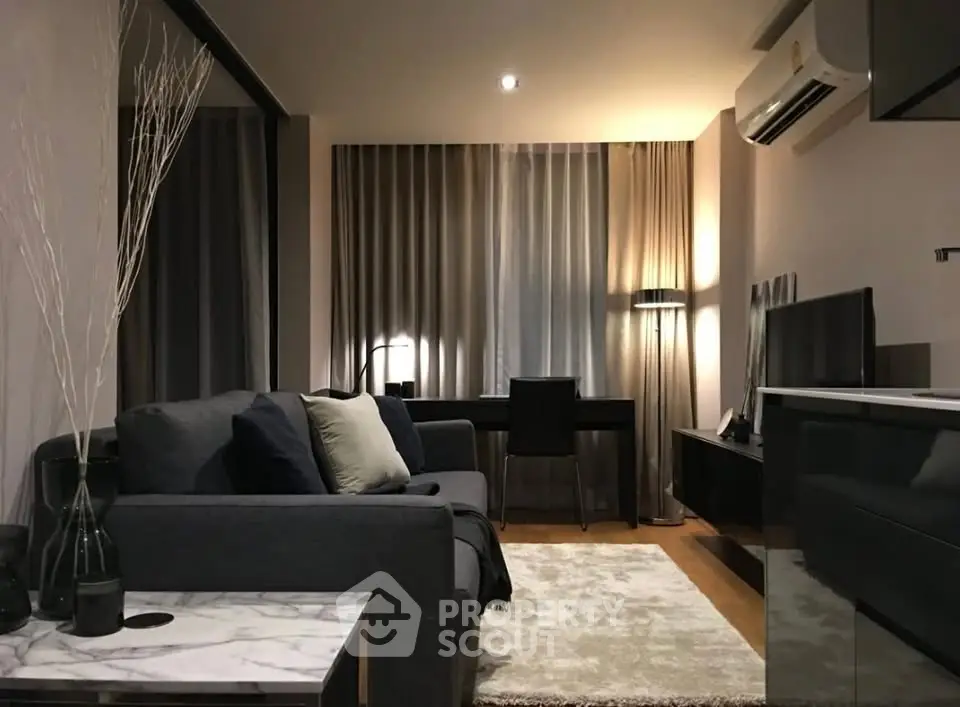 Modern living room with stylish decor and cozy ambiance, featuring a sleek sofa and elegant lighting.