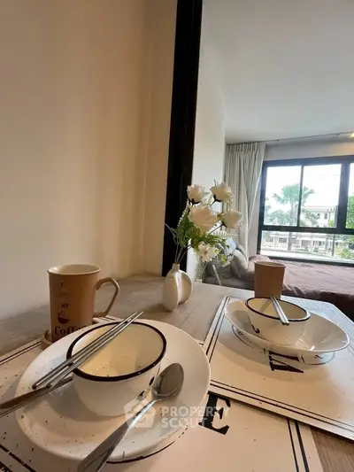 Cozy bedroom with dining setup and large window view
