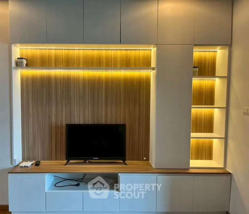 Modern living room with stylish TV unit and ambient lighting