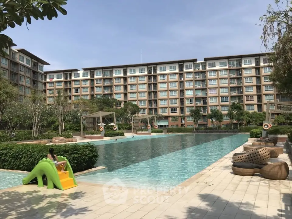 Luxurious apartment complex with stunning pool and lush greenery, perfect for relaxation and leisure.