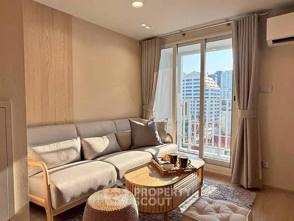 Chic living room with cozy sofa and city view balcony in modern apartment