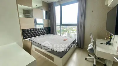Modern bedroom with large window and city view, featuring a comfortable bed and sleek workspace.