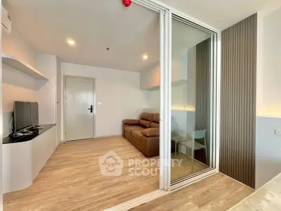 Modern living room with sleek design and glass partition in a stylish apartment.