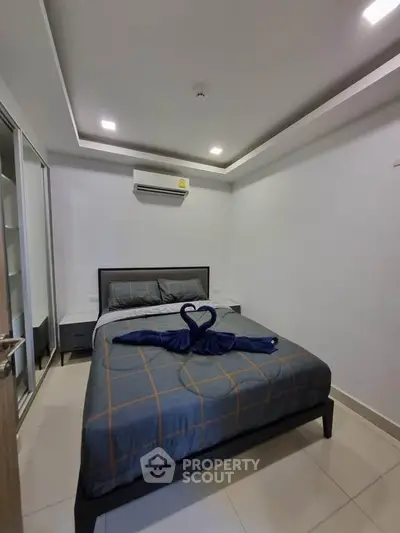Modern bedroom with stylish decor and air conditioning in a cozy apartment.