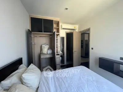 Modern bedroom with open closet and air conditioning, showcasing sleek design and ample storage space.