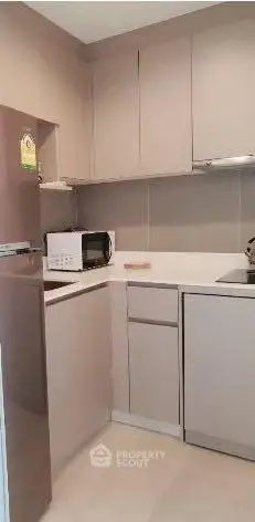 Modern compact kitchen with sleek cabinetry and appliances