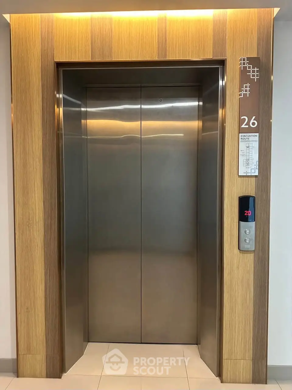 Modern elevator with sleek wooden paneling on the 26th floor, ideal for luxury high-rise living.