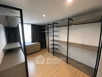 Spacious walk-in closet with modern shelving and natural light.