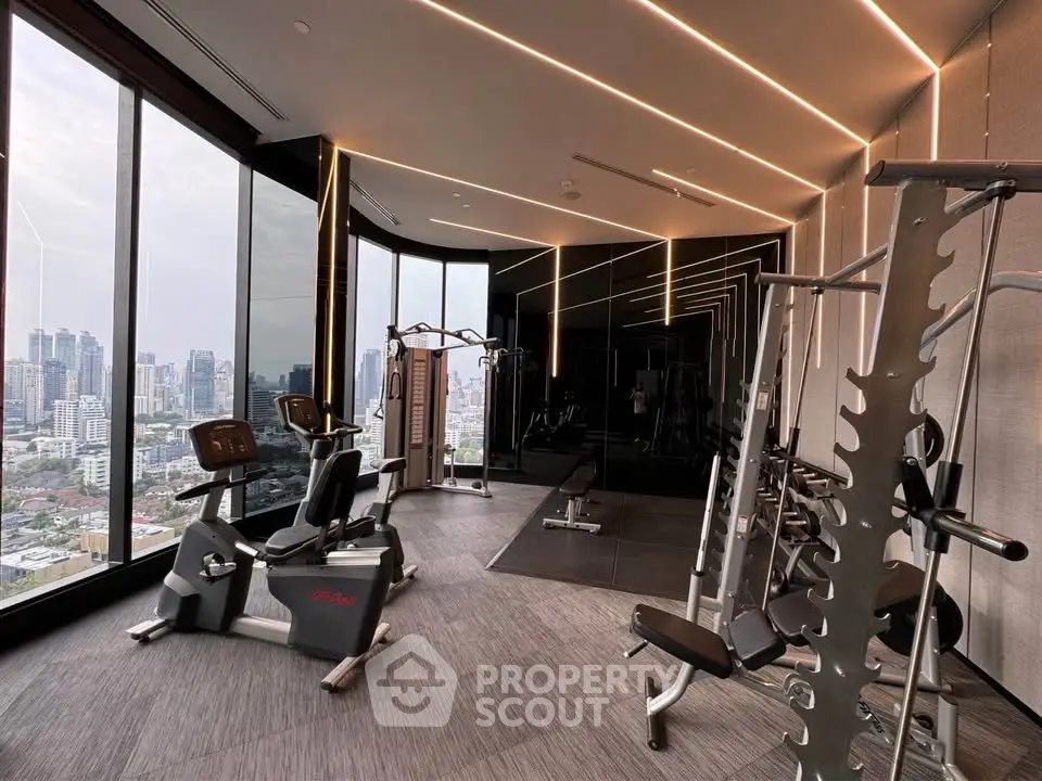 Luxurious high-rise gym with panoramic city views and modern fitness equipment.