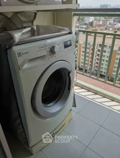 Modern washing machine on a balcony with city view, perfect for urban living convenience.
