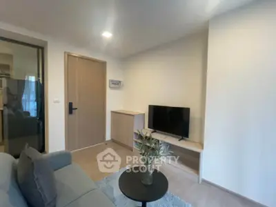 Modern living room with sleek furniture and a cozy ambiance, perfect for relaxation and entertainment.
