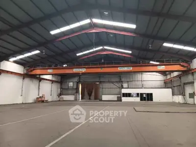 Spacious industrial warehouse with high ceilings and ample storage space.
