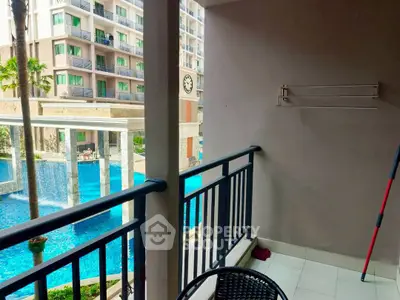 Charming balcony with pool view in modern apartment complex