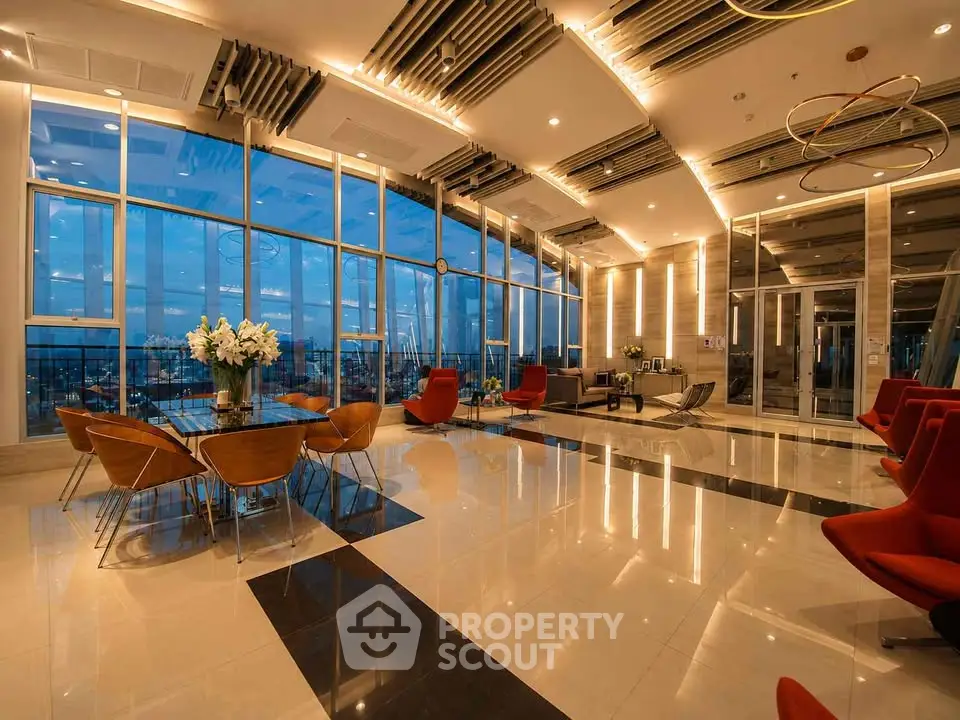 Luxurious high-rise building lobby with panoramic city views and modern decor.