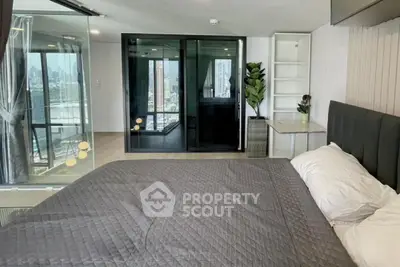 Modern bedroom with city view and glass sliding doors in luxury apartment