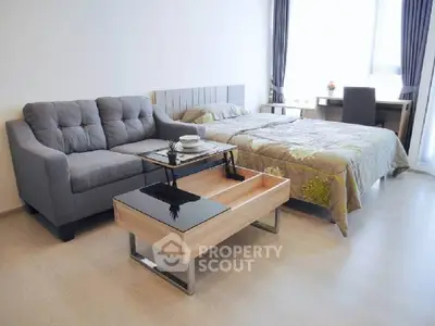Modern studio apartment with cozy living area and stylish furnishings.