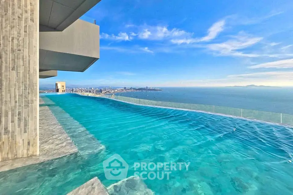 Stunning rooftop infinity pool with breathtaking ocean view in luxury high-rise building.