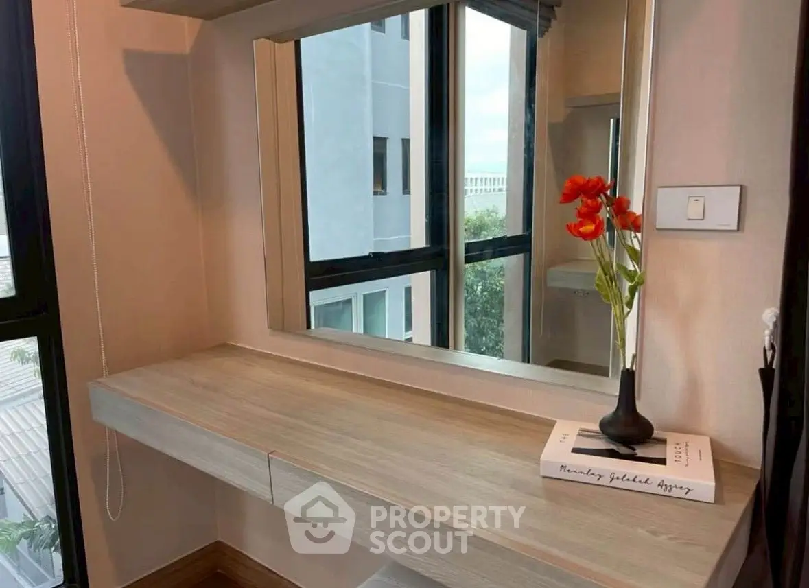 Stylish vanity area with large mirror and modern decor in a bright room with natural light.