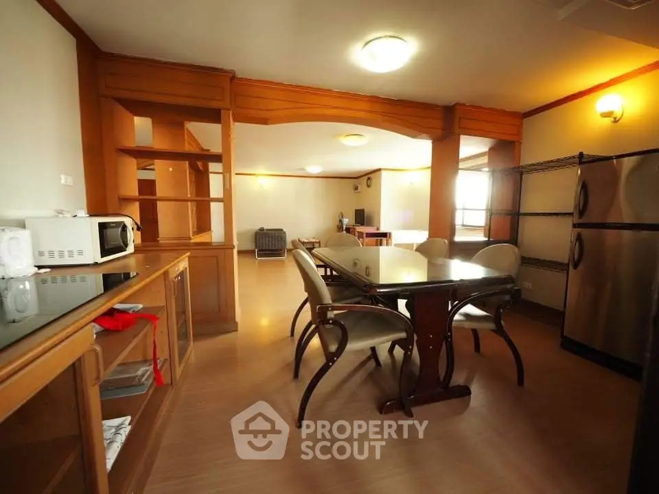 Spacious dining area with wooden accents and modern appliances in open layout.