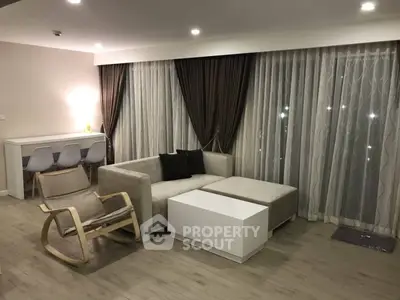 Modern living room with stylish furniture and elegant curtains