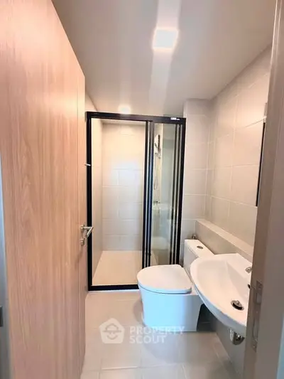 Modern bathroom with sleek shower and contemporary fixtures in a stylish apartment.