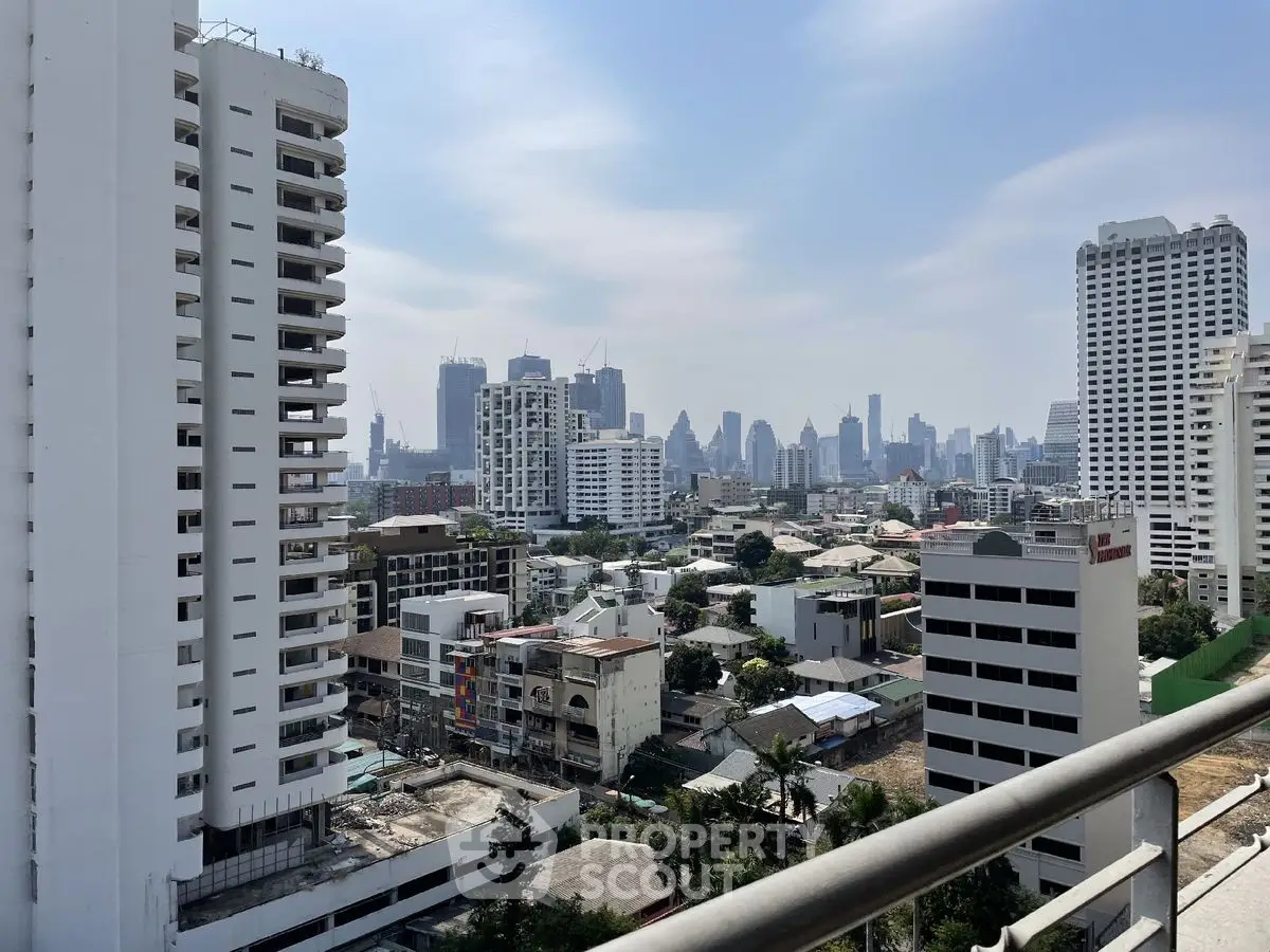 Stunning cityscape view from a high-rise balcony showcasing urban skyline and modern architecture.