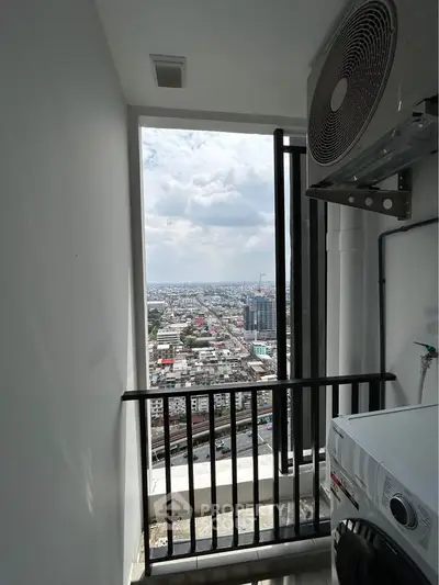 High-rise apartment balcony with city view and air conditioning unit.