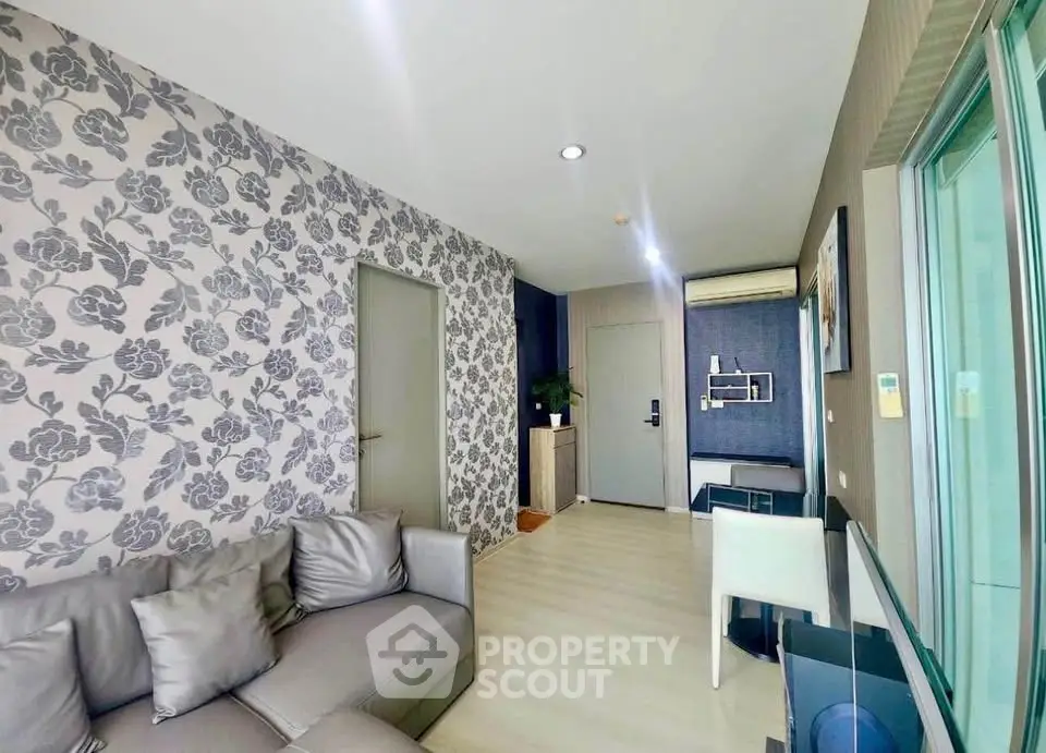 Modern living room with stylish wallpaper and sleek furniture in a contemporary apartment.