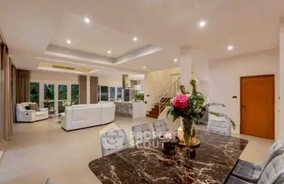 Luxurious open-plan living and dining area with elegant decor and modern furnishings.