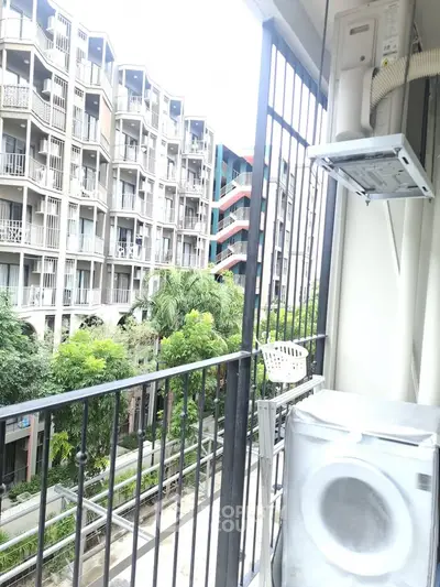 Modern apartment balcony with washing machine and city view