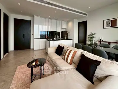 Modern open-plan living room with sleek kitchen and stylish decor