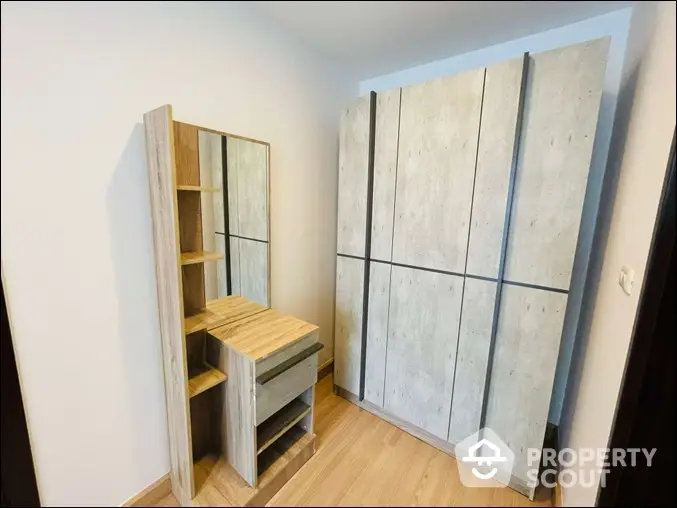 Modern bedroom with stylish wardrobe and dressing table in minimalist design.