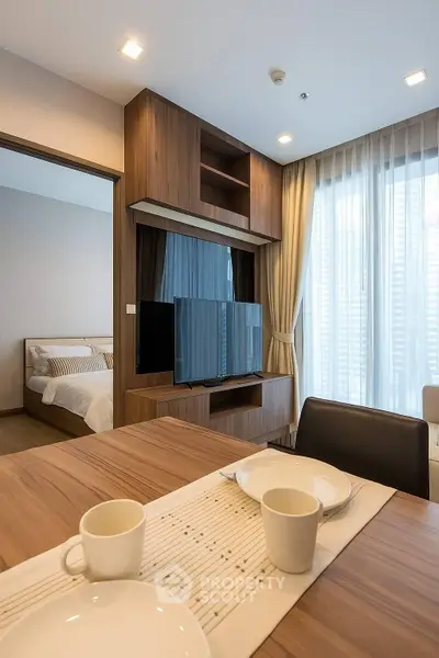 Modern living room with wooden furniture and cozy bedroom view
