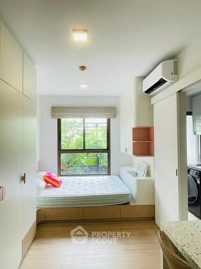 Modern bedroom with built-in storage and large window view