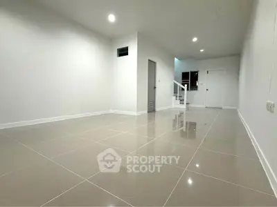 Spacious modern interior with glossy tiled flooring and minimalist design