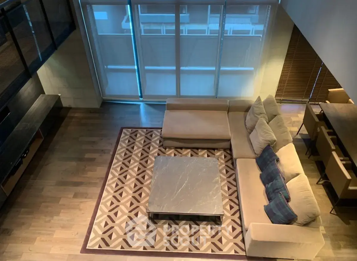 Spacious modern living room with stylish sectional sofa and elegant coffee table, perfect for relaxation and entertainment.