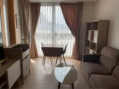 Cozy living room with modern furniture and large windows for natural light.