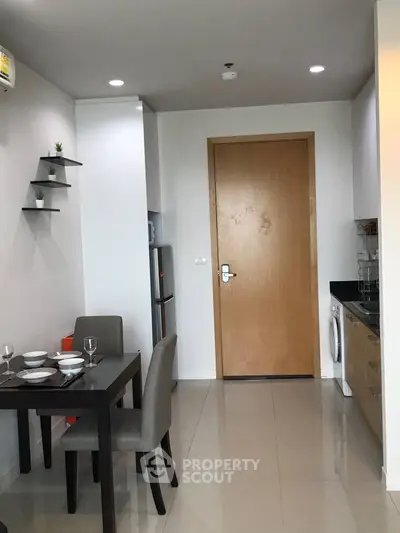 Modern kitchen with dining area and sleek appliances in a stylish apartment