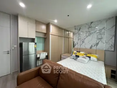 Modern studio apartment with sleek design and marble accent wall