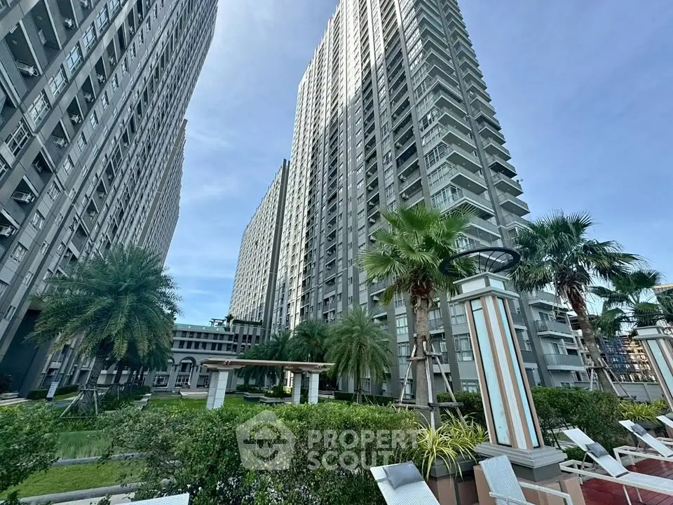 Stunning high-rise residential buildings with lush garden and palm trees