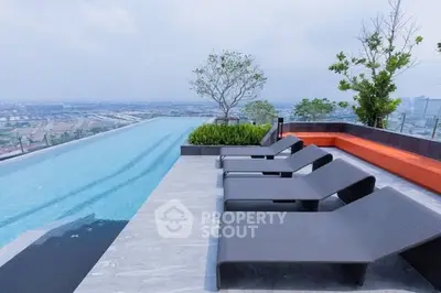 Luxurious rooftop infinity pool with stunning city views and modern lounge chairs.