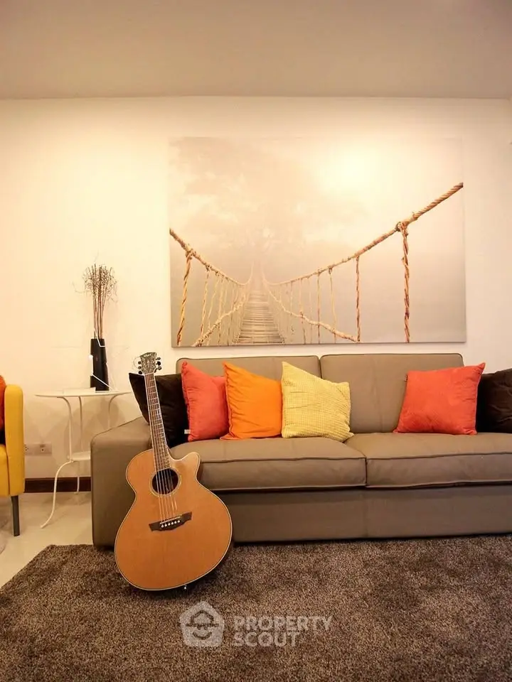Stylish living room with cozy sofa, vibrant cushions, and artistic wall decor, perfect for modern living.