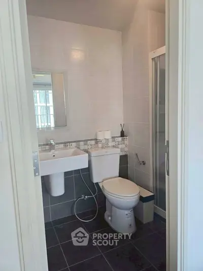 Modern bathroom with sleek fixtures and a glass shower enclosure, perfect for contemporary living.