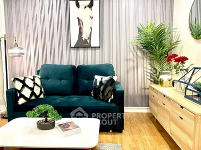 Stylish living room with plush sofa, modern decor, and vibrant plants.