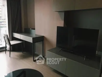 Modern living room with sleek furniture and large TV, perfect for urban living.